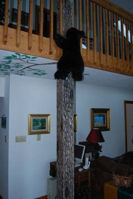 Cabin Art - A bear climbing a tree