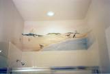 Beach scene mural over a shower stall