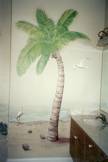 Beach scene mural on bathroom wall